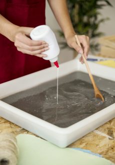 close-up-woman-s-hand-pouring-glue-paper-pulp